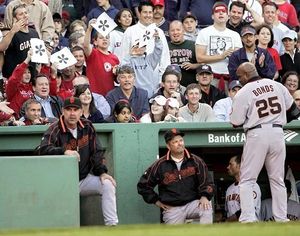 Boston Red Sox players waving to teammates in dugout from second