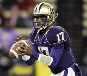 Washington quarterback Keith Price smiles as players greet each other after  the team beat Arizona in