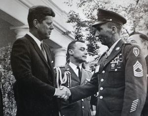 President Kennedy shakes hands with Ross at the White House in May 1963. 