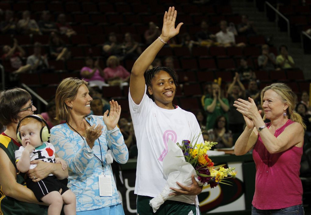 Seattle Storm owners Ginny Gilder, second from left, and Dawn Trudeau, far right, celebrate Tanisha Wright’s 10th season with the team.