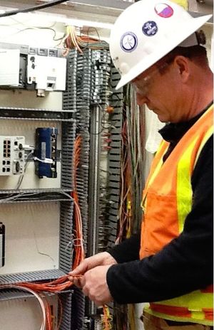 Electrician Mike Dubenko rewires a control box.