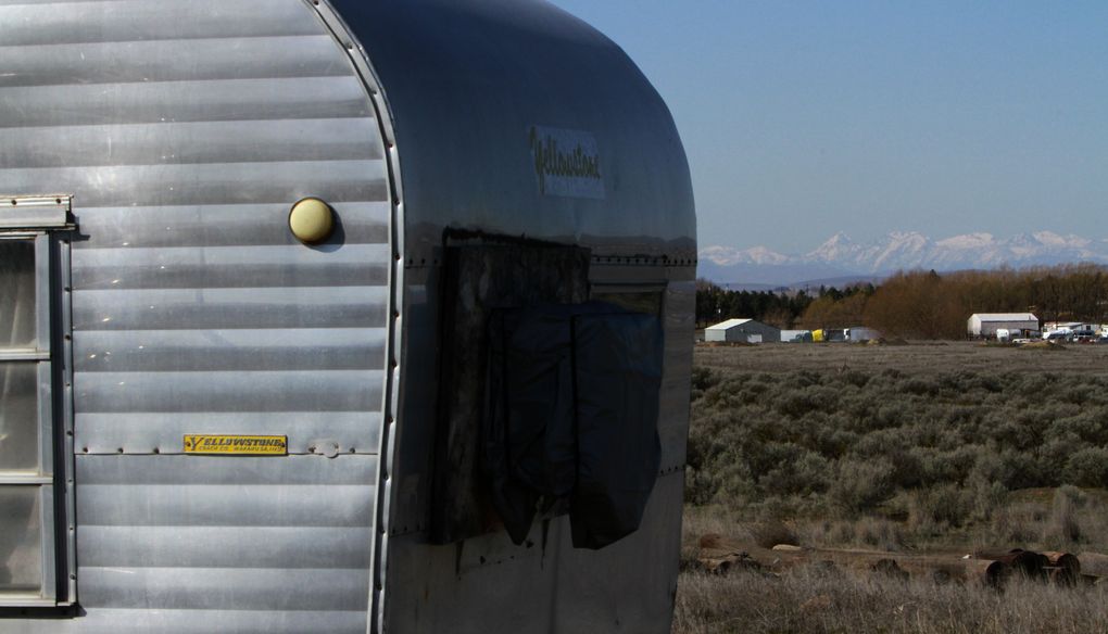 After their mobile home was repossessed, the Ackleys cobbled together a home that includes this old travel trailer, which houses their kitchen. (Ken Lambert / The Seattle Times)
