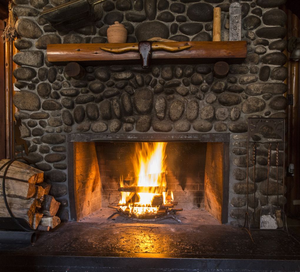 A carved longhorn steer head decorates the fireplace mantel at Copper Creek Lodge. (Steve Ringman/The Seattle Times)