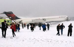 In this photo provided by Amber Reid, a passenger on Delta Flight 1086, passengers leave the plane after the aircraft skidded off the runway while landing, Thursday, March 5, 2015, at LaGuardia Airport in New York. Authorities said the plane, from Atlanta, carrying 125 passengers and five crew members, veered off the runway at around 11:10 a.m. before crashing through a chain-link fence and coming to rest with its nose perilously close to the edge of an icy bay. (AP Photo/Amber Reid) NYR102