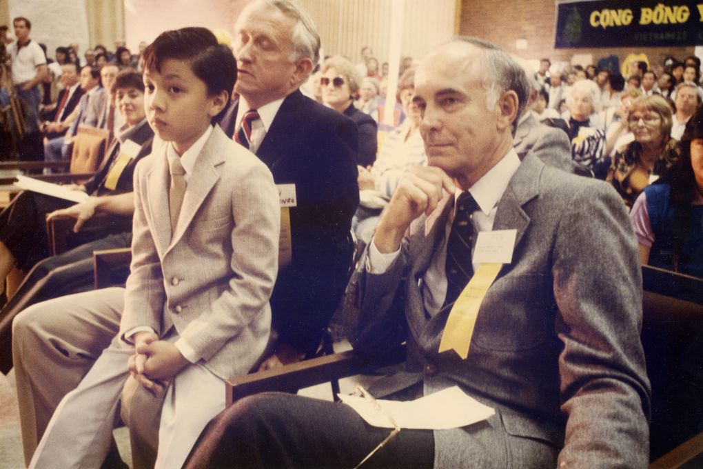 In 1985, then-U.S. Sen. Dan Evans, right, met Evans Nguyen (sitting on Secretary of State Ralph Munro’s lap), who was named to honor Evans’ advocacy for Vietnamese refugees in Washington state. Dan Evans laid the foundation for the state’s resettlement program. (Courtesy of Nguyen family).