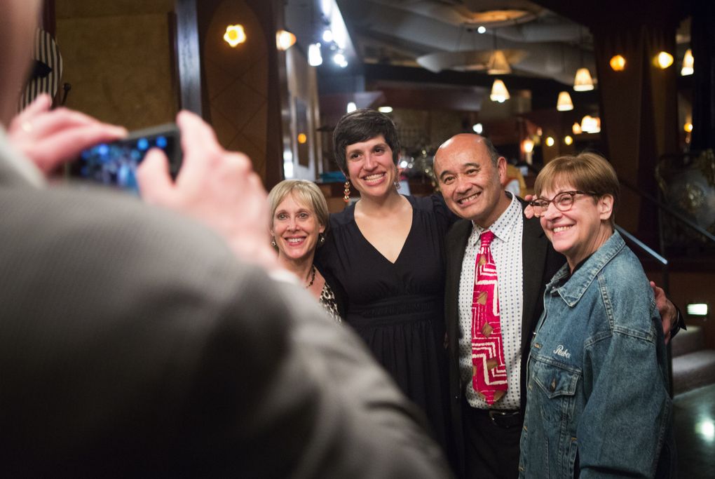 David Gilbert takes a photo of Myrnie Van Kempen, left; his daughter Bronwen Houck, a Roosevelt High School student from 1991-1995; retiring drama teacher Ruben Van Kempen; and Anne Gilbert during Van Kempen’s retirement party. (Lindsey Wasson / The Seattle Times)