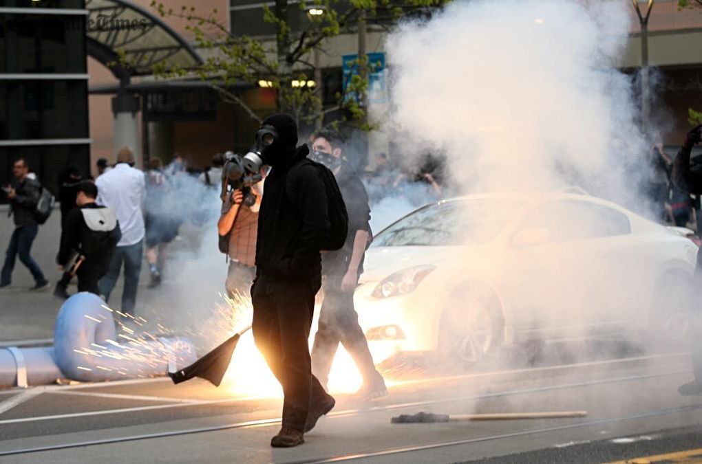 Seattle police deploy flash bangs during May Day protests near Seattle Central College. (Lindsey Wasson / The Seattle Times)
