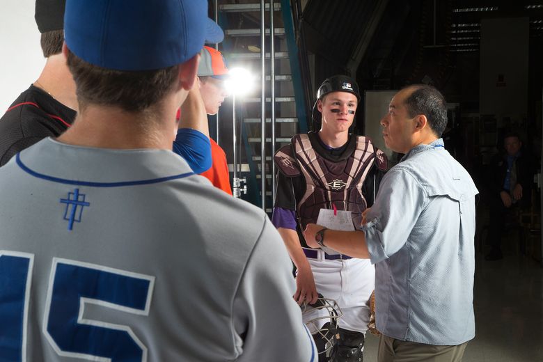 Photographer John Lok instructs baseball players during their portraits at the Star Times high school athlete photo shoot. (Katie G. Cotterill / The Seattle Times)