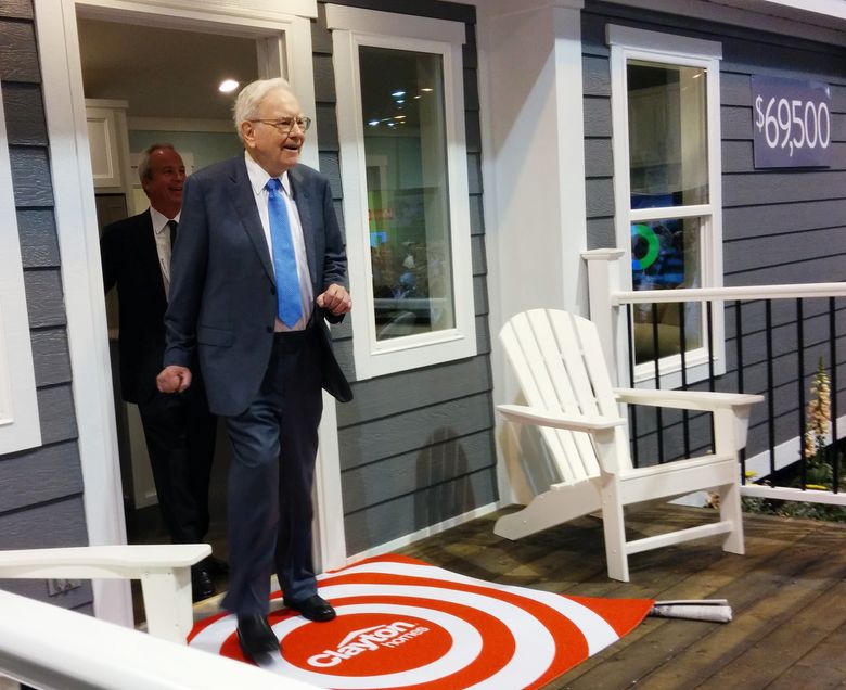Warren Buffett and Clayton Homes CEO Kevin Clayton walk out of a Clayton mobile home before the Berkshire Hathaway shareholder meeting in Nebraska earlier this month. (Mike Baker / The Seattle Times)