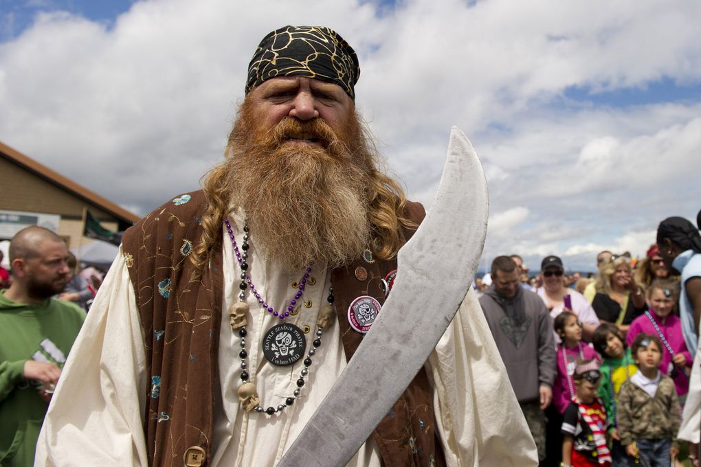 Ed Bussman, a Seafair Pirate, advances moves in to take the key to the city from the mayor during the Seafair Pirates Landing on Alki Beach. They land this year on June 27. (Maddie Meyer / The Seattle Times, 2014)