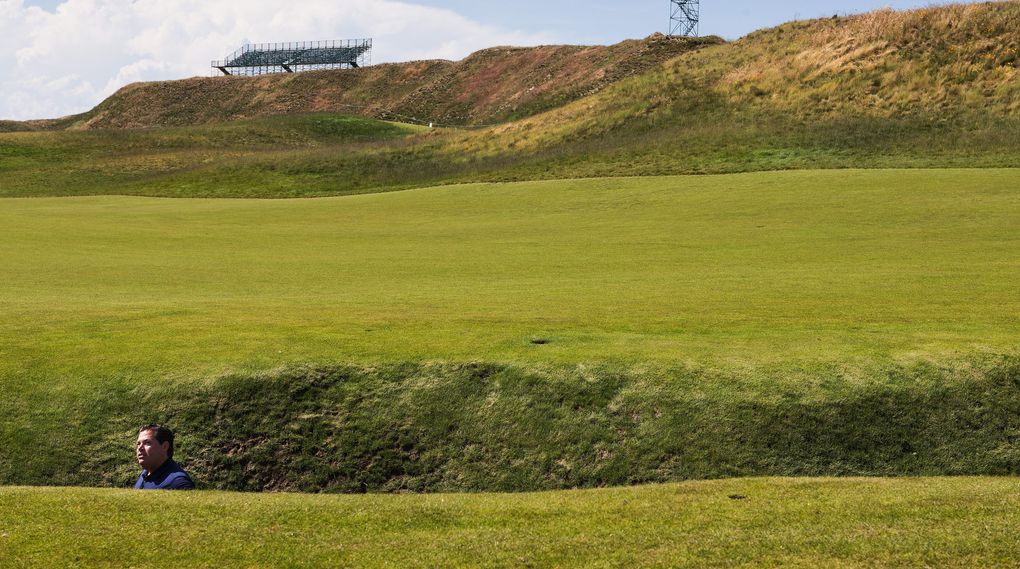 Tournament director Danny Sink stands at the bottom of the “Chambers Basement,” the 10-foot-deep pot bunker in the middle of the 18th fairway at Chambers Bay, which is hosting the U.S. Open. (Dean Rutz/The Seattle Times)