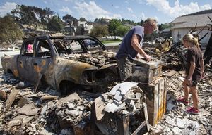 Bill Reed goes through the toolkit in what had been his garage, while daughter Erin searches in vain for the cell phone she’d left behind. The home Diane and Bill Reed shared with their daughters, Abby and Erin, was among those destroyed by Sunday’s fast-moving Sleepy Hollow fire in Wenatchee. It was the family’s first visit to the property at 2050 Maiden since the fire broke out.