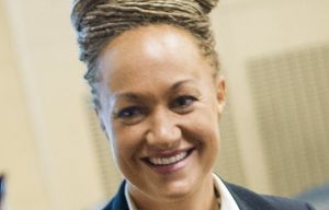 FILE- In this Friday, Jan. 16, 2015 file photo, Rachel Dolezal, Spokane’s newly elected NAACP President, smiles as she meets with Joseph M. King of King’s Consulting, left, and Dr. Scott Finnie, director and senior professor of  EWU’s Africana Education Program before the start of a Black Lives Matter Teach-In on Public Safety and Criminal Justice  at EWU in Cheney, Wash.  (Tyler Tjomsland/The Spokesman-Review via AP, File) COEUR D’ALENE PRESS OUT WASPO101