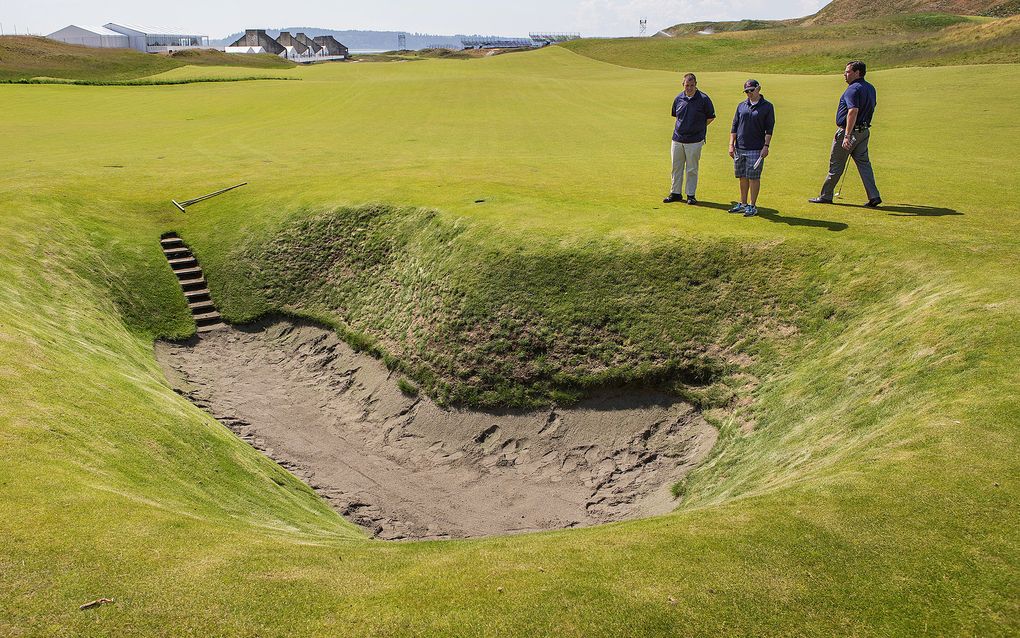 The 10-foot-deep pot bunker in the middle of the 18th fairway at Chambers Bay comes complete with nine steps. It was added to the original design of Chambers Bay to make the hole more challenging for the U.S. Open. (Dean Rutz/The Seattle Times)