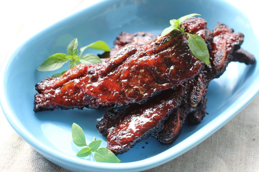 An orange marmalade-based barbecue sauce caramelizes into a thick, sticky, sweet-and-tangy lacquer on these short ribs. (Matthew Mead/AP)