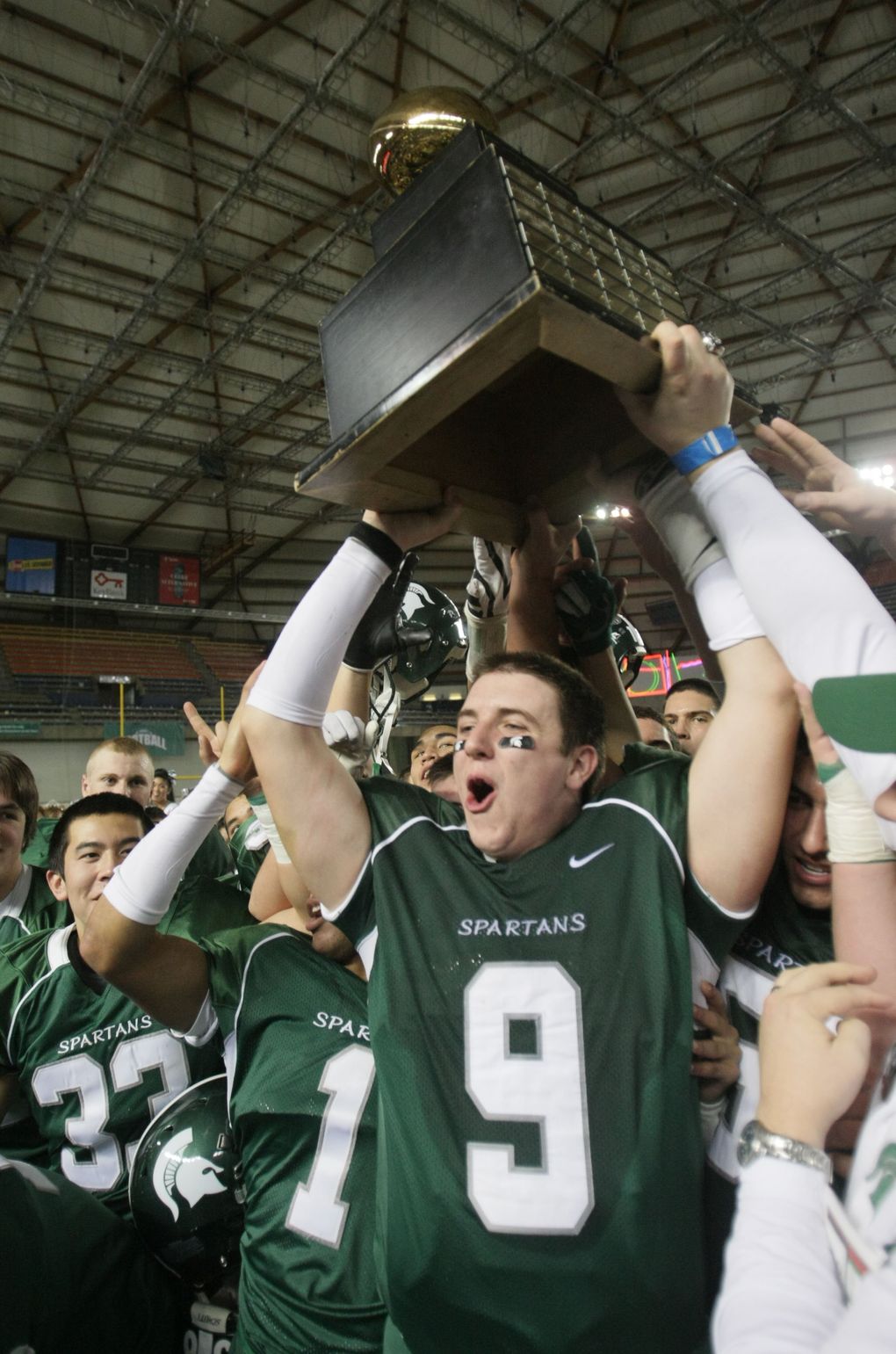 Skyline’s Jake Heaps hoists another State Trophy over his head as the Spartans take the 4A Title 45-21 over Farris at the 4A State Title game at the Tacoma Dome, Saturday, December 5, 2009. (Jim Bates / The Seattle Times)