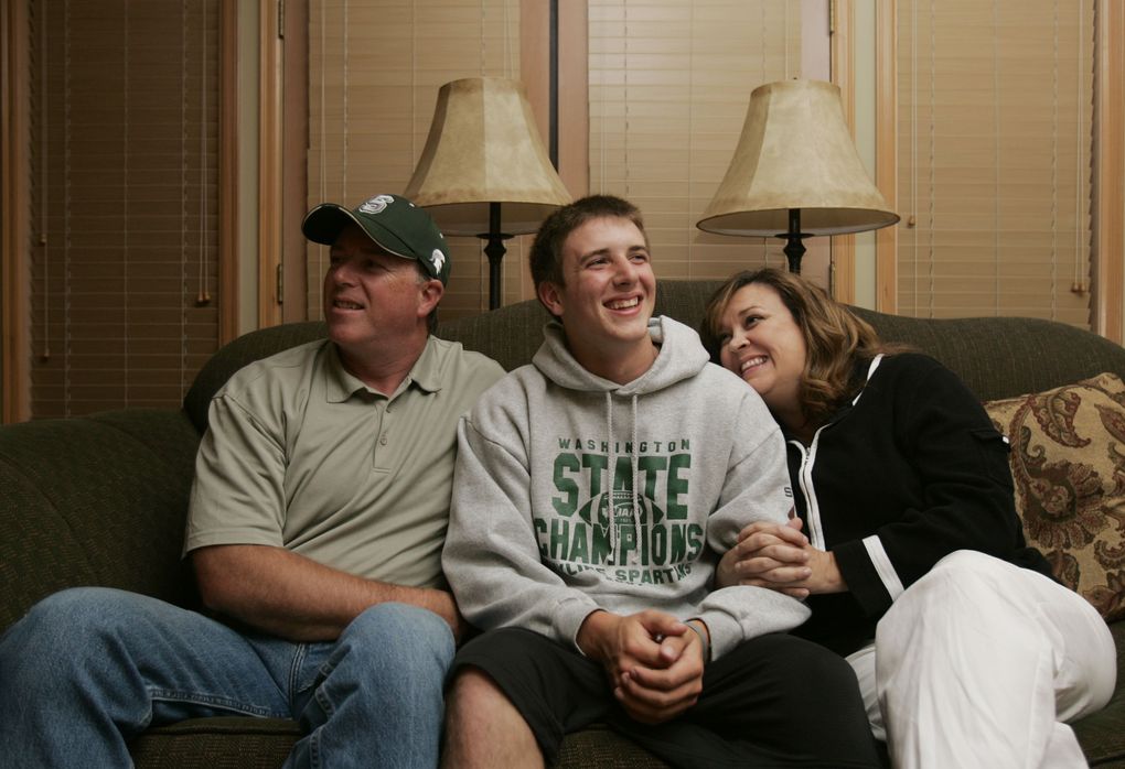 Skyline High School quarterback Jake Heaps poses with his parents Kelly and Steve Heaps inside their home in Sammamish. (Erika Schultz / The Seattle Times)