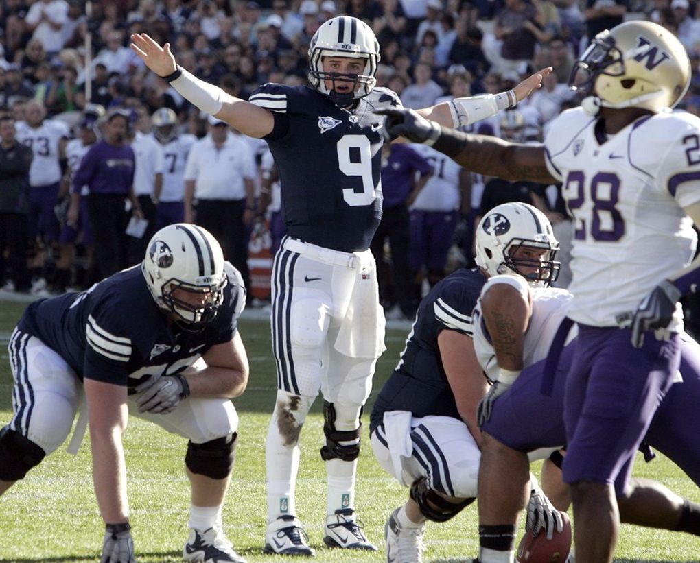BYU quarterback Jake Heaps (9) directs the Cougar offense as Washington cornerback Quinton Richardson counters at LaVell Edwards Stadium in Provo, Utah, on Saturday, September 04, 2010. The Cougars held off the visiting Huskies, 23-17. (Jim Bates/Seattle Times)