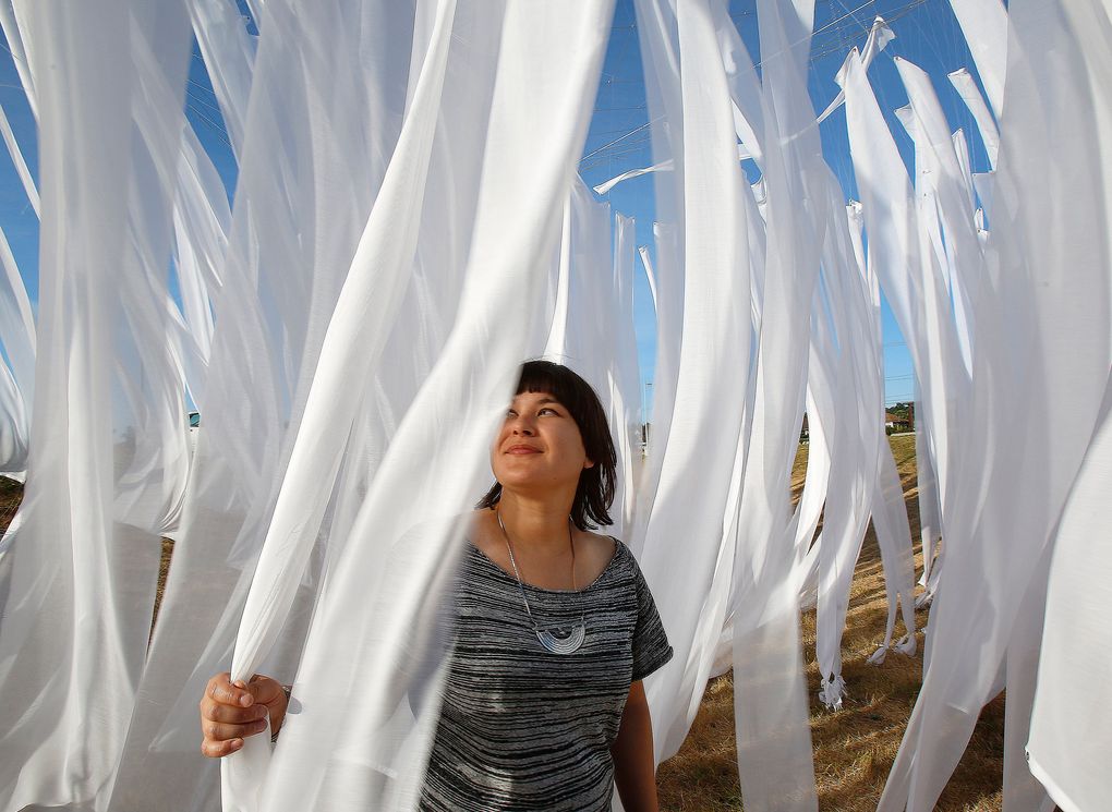 Artist Frances Nelson stands surrounded by her installation called “Meanders,” made from layers of suspended fabric. Her piece is just part of a summerlong project called “Duwamish Revealed,” a creative celebration of Seattle’s only river. (Sy Bean/The Seattle Times)