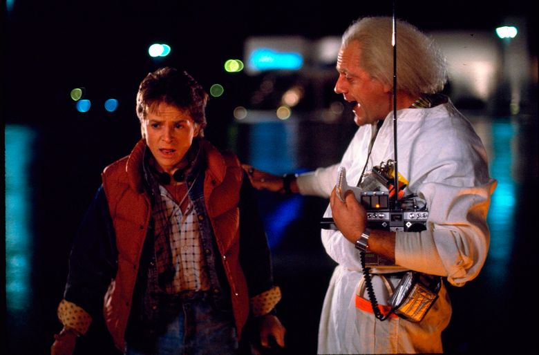 This photo released by Universal Pictures shows, Michael J. Fox, left, as Marty McFly, and Christopher Lloyd as Dr. Emmett Brown, in a scene from the 1985 film, “Back to the Future.” Co-stars Lea Thompson, Lloyd and others gather on Tuesday, June 30, 2015, for a special screening of the 1985 Michael J. Fox time-travel blockbuster, to be presented on the massive Hollywood Bowl screen with musical score performed live and orchestra conducted by the original composer, Alan Silvestri. (Universal Pictures via AP)