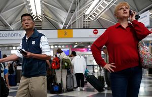Travelers look at the United Airlines flight monitor for flight status near the economy check-in area of O’Hare International Airport as flights were delayed due to a stoppage on Wednesday, July 8, 2015. United grounded all U.S. flights because of “automation issues.” Planes at O’Hare were not leaving the gates, and some passengers said they were unable to book flights. (Jose M. Osorio/Chicago Tribune/TNS)
