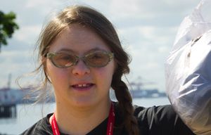 Devon Adelman, 18, a volunteer at the Seattle Aquarium, holds up one of the many bags of trash she picked up on the waterfront along Myrtle Edwards Park Thursday, July 15, 2015.  Adelman has Down syndrome, but has represented her family and Seattle in a variety of different events related to inclusivity.  She is going to the White House for Michelle Obama’s “Reach Higher” inclusivity event. She is also studying marine biology at Highline Community College in Des Moines, and volunteers at the aquarium. Sea species, especially the octopus, are one of her main interests.