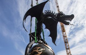 Monday August 24, 2015  Tower crane rigging workers at the Troy building site in Seattle watch as a dragon sculpture by artist Marcus Devine is lifted up off it’s trailor and placed on a new perch overlooking Amazon from the Troy construction site.