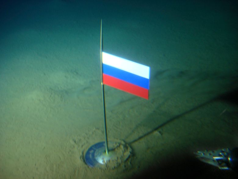 FILE – In this Thursday, Aug. 2, 2007 file made available by the Association of Russian Polar Explorers on Wednesday, Aug. 8, 2007, photo a titanium capsule with the Russian flag is seen seconds after it was planted by the Mir-1 mini submarine on the Arctic Ocean seabed under the North Pole during a record dive. Russia says it has submitted its bid for vast territories in the Arctic to the United Nations. The Foreign Ministry said Tuesday, Aug. 4, 2015, that Russia is claiming 1.2 million square kilometers (over 463,000 square miles) of Artic sea shelf.  (AP Photo/Association of Russian Polar Explorers, file)