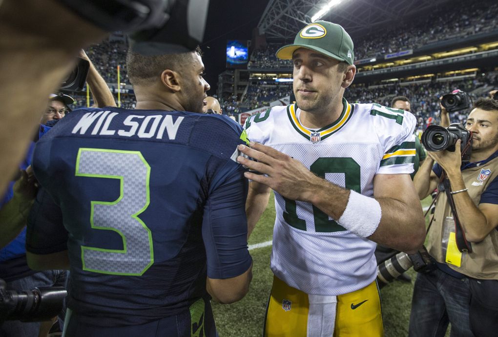 Seahawks quarterback Russell Wilson and Packers quarterback Aaron Rodgers shake hands after the game against Green Bay, Thurs., Sept. 4, 2014, at CenturyLink Field in Seattle. (Mike Siegel / The Seattle Times)