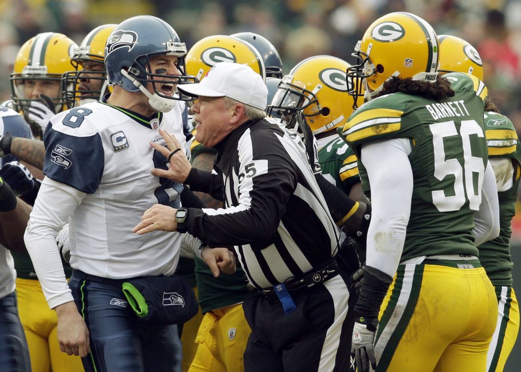 Referee Walk Coleman gets in the middle of an argument between Seattle Seahawks’ Matt Hasselbeck (8) and Green Bay Packers’ Nick Barnett (56) during the first half of an NFL football game Sunday, Dec. 27, 2009, in Green Bay, Wis. (AP Photo/Mike Roemer) WIMG117 (Mike Roemer / The Associated Press)