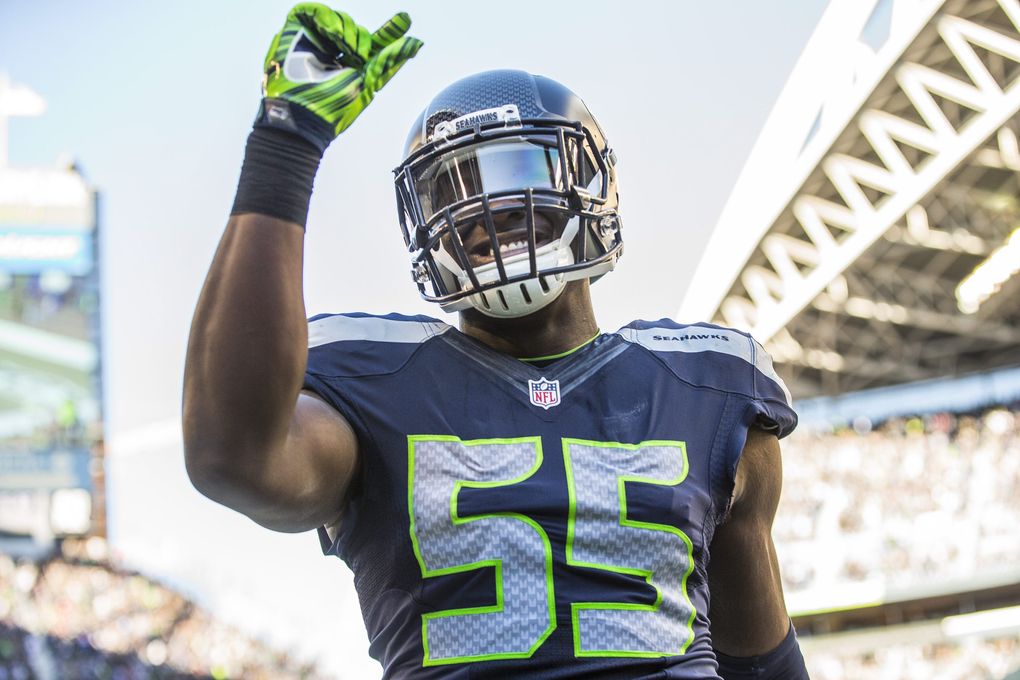 Frank Clark shows how very close he came to returning a Bears fumble for a touchdown in the fourth. (Dean Rutz / The Seattle Times)
