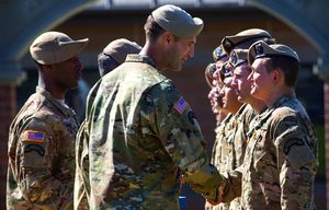 LTC Jay Bartholomees, commander, (center) presents a joint service commendation medal to a recipient  at Joint Base Lewis McChord Friday morning, September 11, 2015.  The Second Battalion 75th Ranger Regiment held an awards ceremony for honorary member inductions, ranger combat and awards and valorous unit awards.