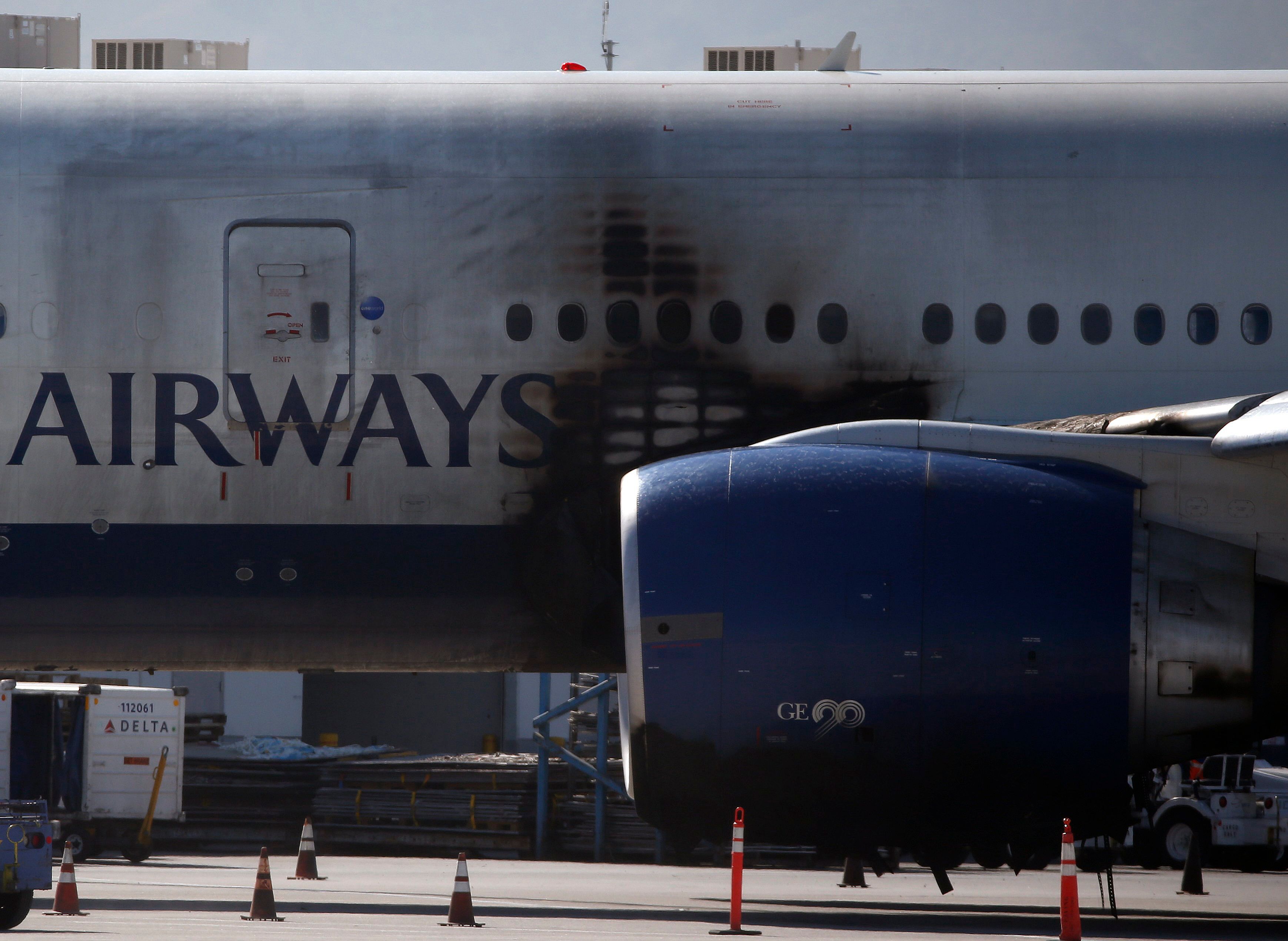 Engine parts pierced protective case in British Airways 777 fire