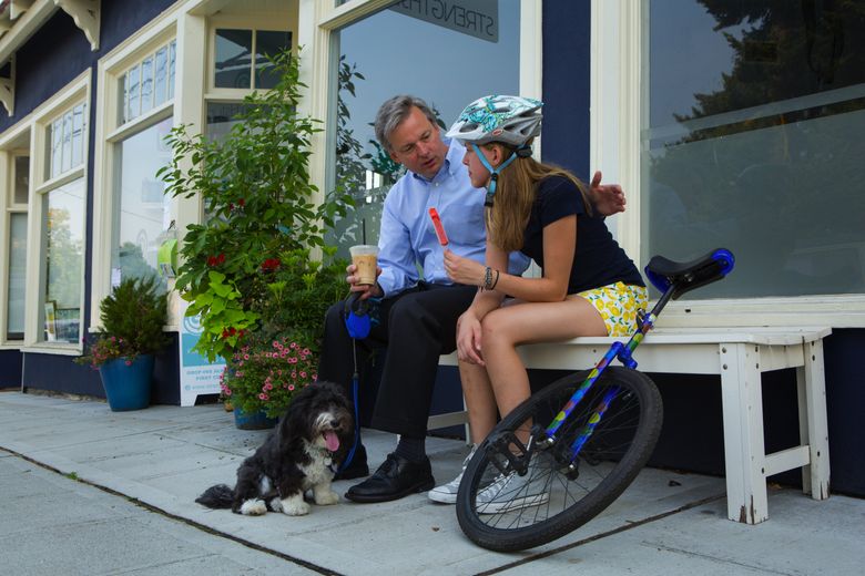Dr. Jim Copeland and his daughter, Sophia, chat in front of a store where they went to get coffee and ice cream near the family’s Seattle home. Jim and his wife, Pamela, decided to have only one child and keep their daughter involved in many activities. (Ellen M. Banner/The Seattle Times)