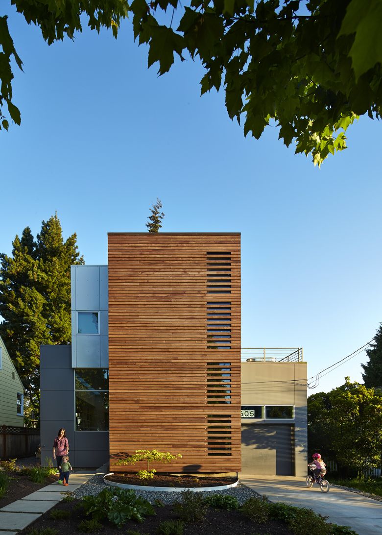 The old bungalow fell for this two-story contemporary with aluminum composite panel boxes intersecting a vertical central cedar core. The home offers decks on two levels, including the rooftop. It was built by Modern Shelter LLC. (Benjamin Benschneider / The Seattle Times)
