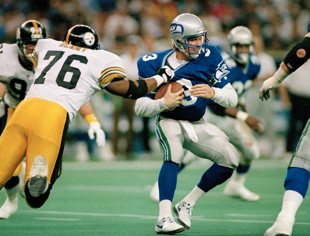 FILE – In this Dec. 26, 1993, file photo, Seattle Seahawks quarterback, Rick Mirer (3) is sacked for a seven-yard-loss by Pittsburgh Steelers’ Kevin Henry (76) during the second quarter of an NFL game in Seattle. Mirer and New England Patriots quarterback Drew Bledsoe were drafted back-to-back as No. 1 and 2. (AP Photos/Gary Stewart, File)