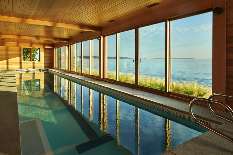 The lap pool, 50 feet long, on the home’s lowest level, seems to sit right off the water. (Benjamin Benschneider/The Seattle Times)