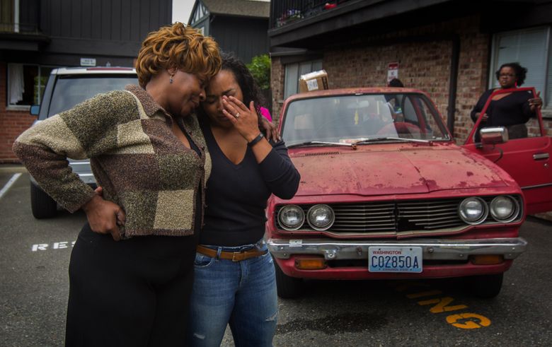 Tiffany Prinos, right, gets a hug from her aunt, Cheryl Harris. Prinos, an only child, recently lost her mother. Prinos came from her home in Missouri to go through her mother’s SeaTac home after she died. (Ellen M. Banner/The Seattle Times)