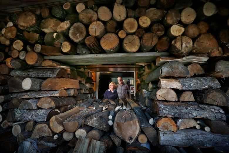Clever stacking of firewood on the front porch of Terri and Bob Tomchak’s cozy home in Bridgton, Maine, allows them to enjoy the view from their living room window, Friday, Oct. 23, 2015. The couple burns about four cords of firewood each winter. Some consumers who may have switched over to wood over the past several years as heating oil prices ratcheted up are feeling a little buyer’s remorse but continue to keep the woodpiles stocked even as prices push over $400 a cord. (AP Photo/Robert F. Bukaty)