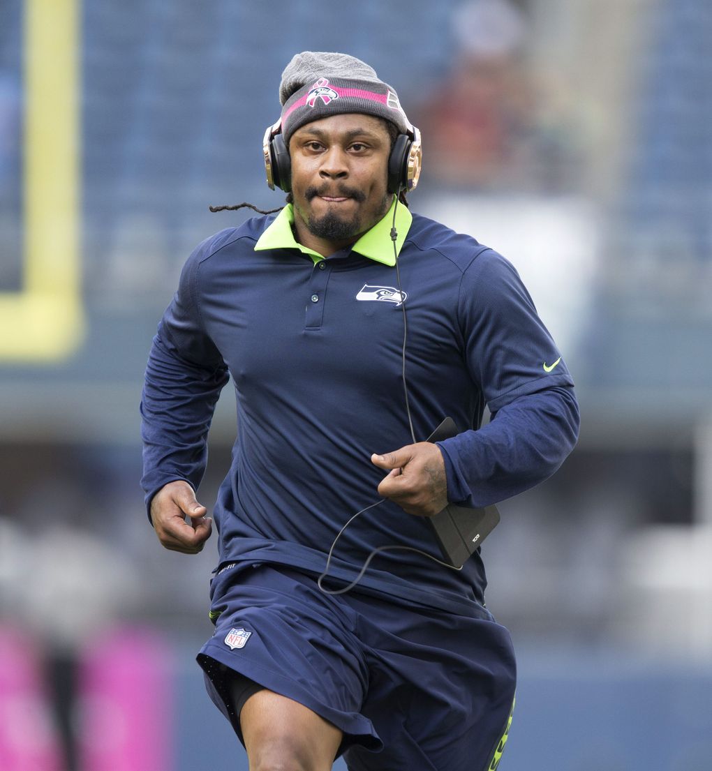 Seahawks running back Marshawn Lynch loosens up on the field before Monday Night Football. (Dean Rutz / The Seattle Times)