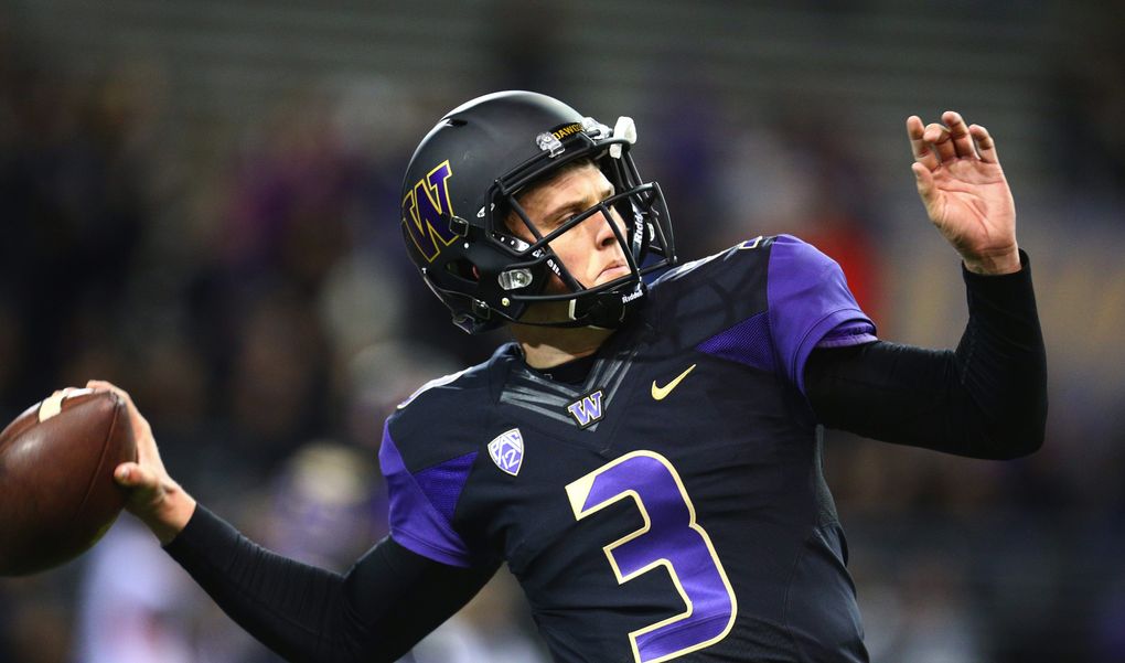 Washington quarterback Jake Browning warms up to face Arizona at Husky Stadium on Saturday. (John Lok / The Seattle Times)