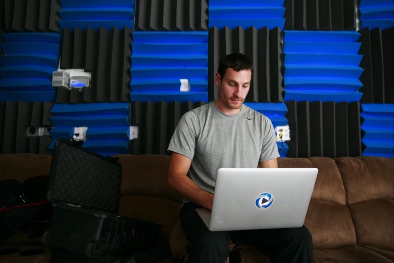 Daniel Segars work on his laptop in the garage of his home north of Seattle. Segars and his wife started Fitness Blender, a popular online website offering workout videos, health plans and recipes. — 0434902863 (Erika Schultz/The Seattle Times)