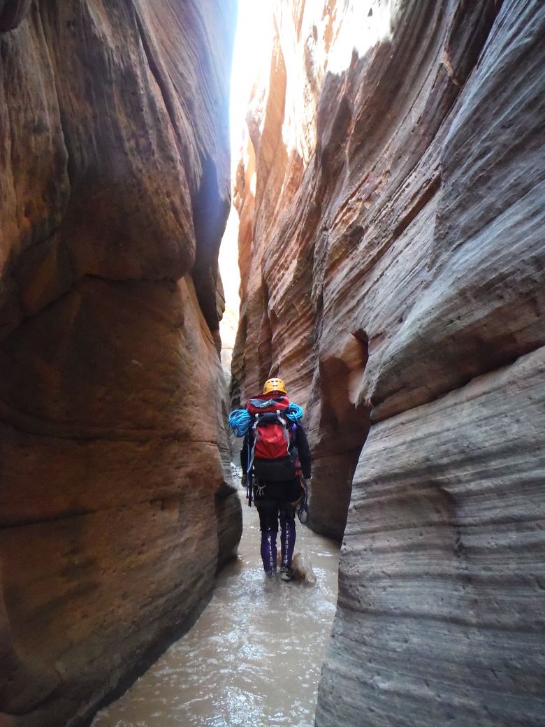 This 2013 photo provided by the National Park Service shows canyoneering in Keyhole Canyon, in Zion National Park, near Springdale, Utah.  Zion National Park officials are retracing what led up to the deaths of seven people in a flooded canyon on Sept. 14, 2015, before a panel assesses what can be done to keep a growing number of visitors safe when spectacular natural settings turn perilous. (National Park Service via AP)