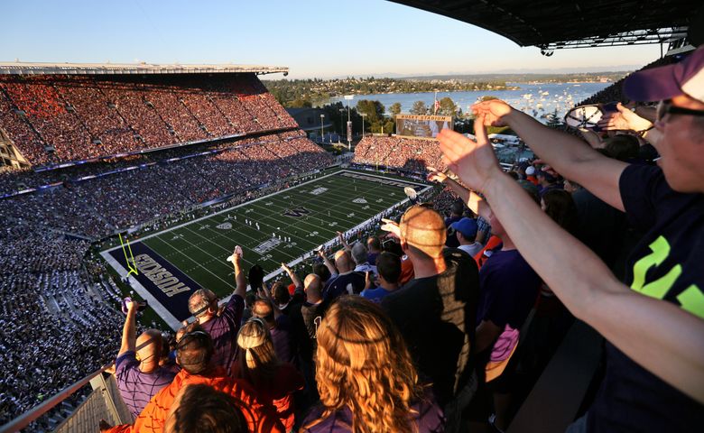 Fans cheer at kickoff as the University of Washington Huskies take on the Boise State Broncos for the first game in the new Husky Stadium on Aug. 31, 2013. (Bettina Hansen/The Seattle Times)