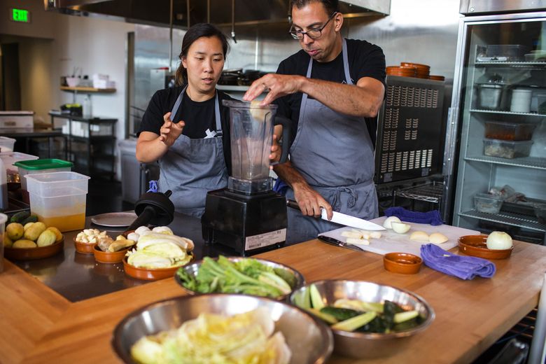 Rachel Yang and her husband, Seif Chirchi, make a batch of kimchi at their Capitol Hill restaurant Trove. (John Lok/The Seattle Times)