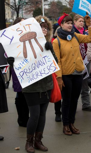 Demonstrators in support of Peggy Young, who sued the United Parcel Service for discrimination when she was placed on unpaid leave after requesting lighter physical work while pregnant, outside the Supreme Court in Washington, Dec. 3, 2014. (Stephen Crowley / The New York Times)