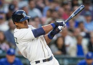 Seattle Mariners on-deck batter Franklin Gutierrez, left, watches