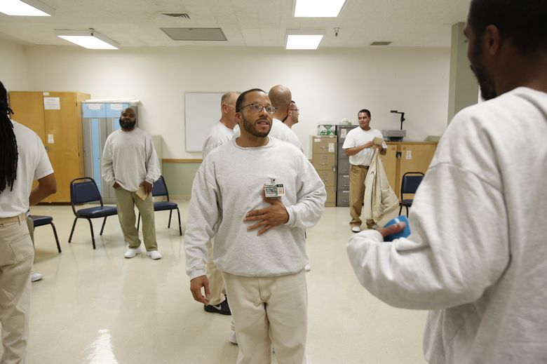 Anthony Wright, serving a life sentence, talks with other inmates after a meeting of the Concerned Lifers Organization at the Monroe Correctional Complex. “I see true transformation,” Wright said, speaking of some fellow inmates. “But guess what? The public doesn’t.” (Sy Bean / The Seattle Times)