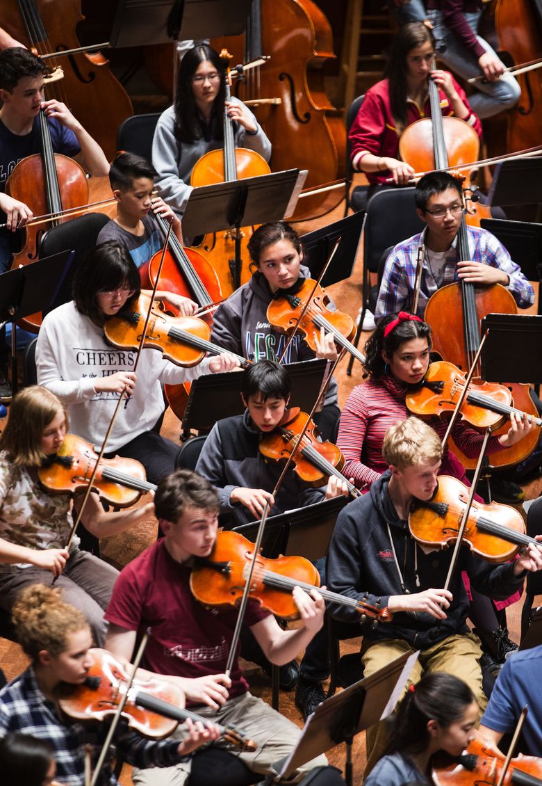Members of the Seattle Youth Symphony Orchestra practice Barber’s Violin Concerto, Op. 14, during a dress rehearsal at Benaroya Hall. The orchestra opens its season on Sunday, Nov. 15 with Johannes Brahms’s Symphony No. 4, along with Glinka’s Russlan und Ludmilla Overture and Barber’s Violin Concerto, Op. 14. (Lindsey Wasson/The Seattle Times)