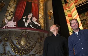 PNB Artistic Director Peter Boal, left, and famed author/illustrator Ian Falconer prepare to unveil the new Nutcracker set at McCaw Hall.  Falconer brought to life the children’s book “Olivia” the pig, and has drawn her into the set at left.